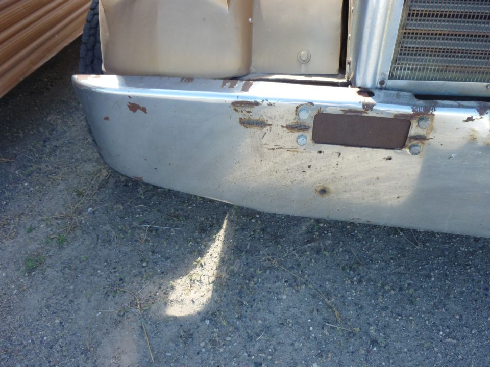 Truck bumper with rust spots and visible bolts
