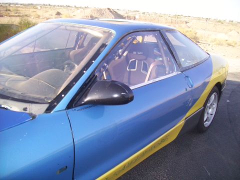 1995 Ford Probe - This 1995 Ford Probe has been modified with racing seats and a roll cage, painted blue and yellow.