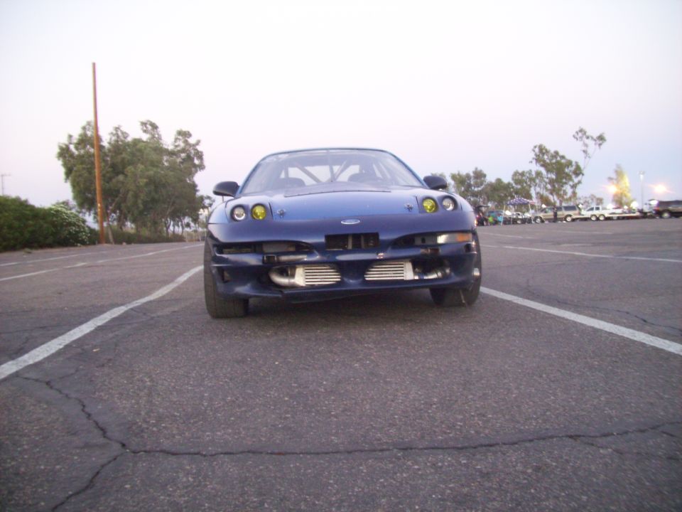 Front view of a blue 1995 Ford Probe with yellow headlights and exposed intercoolers