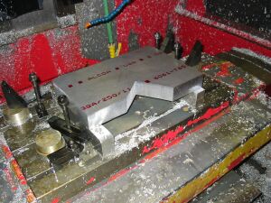 1993 Ford Taurus - Machining a custom metal part on a milling machine, covered in metal shavings.