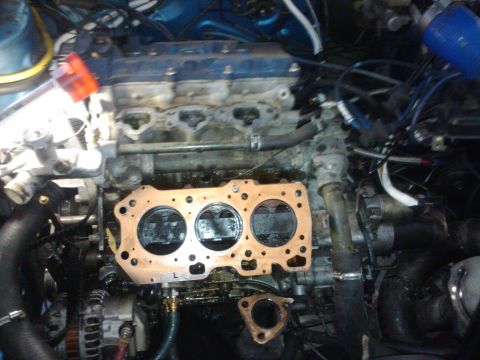 1995 Ford Probe - Engine block with head gasket removed, showing pistons and cylinder bores.
