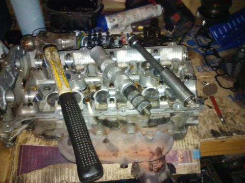 1995 Ford Probe - Engine cylinder head disassembled with tools, likely for repair or maintenance.