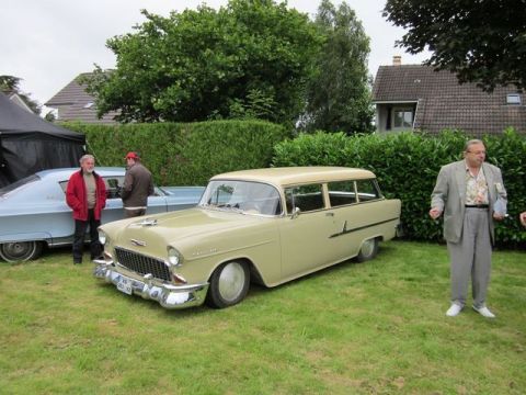 1991 Ford LTD Crown Victoria - A 1955 Chevrolet Nomad station wagon is displayed at an outdoor car show with another vehicle nearby.