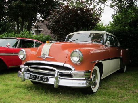 1991 Ford LTD Crown Victoria - This 1954 Pontiac Star Chief features a distinctive orange and white two-tone paint scheme and chrome accents.