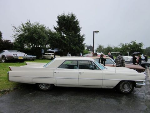1991 Ford LTD Crown Victoria - Side view of a cream-colored 1963 Cadillac Sedan de Ville at a car show.