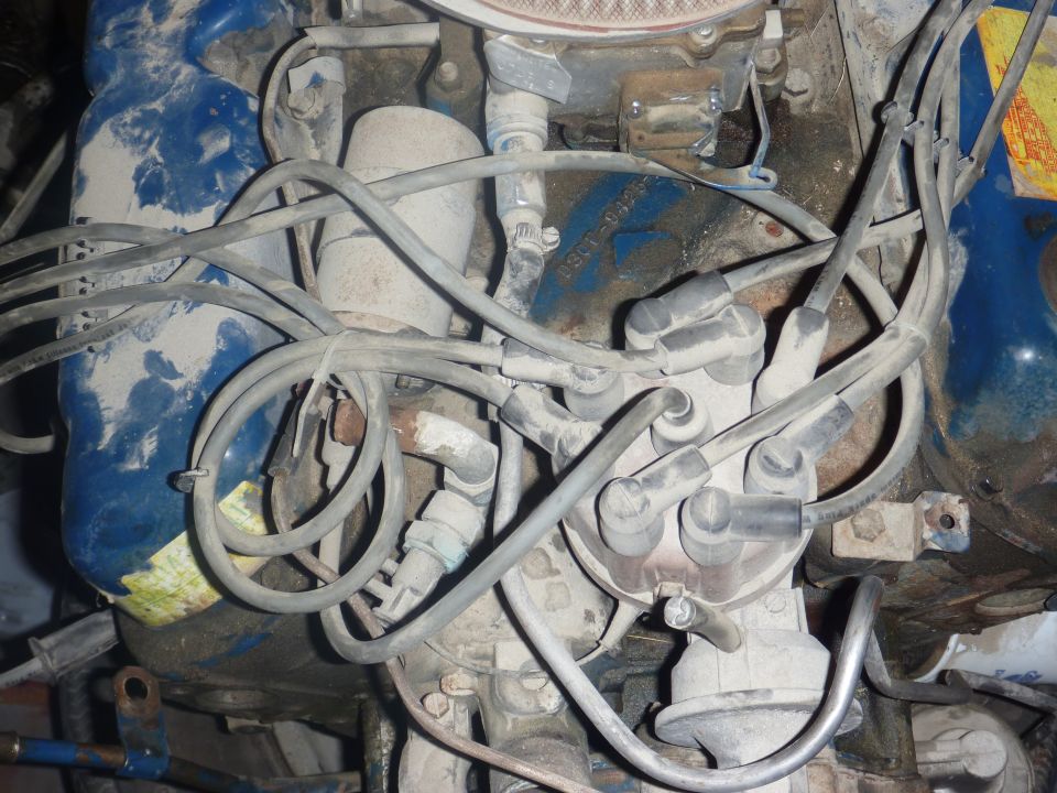 Close-up of an engine's distributor cap with spark plug wires connected