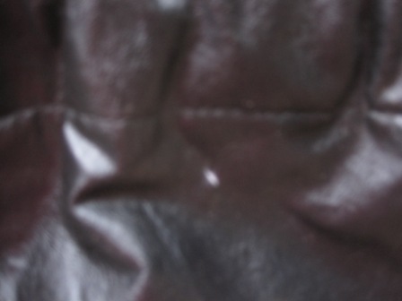 1993 Ford Bronco - The image shows a close-up of wrinkled, dark-colored upholstery inside a vehicle.