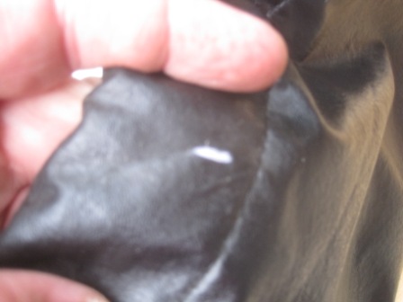 1993 Ford Bronco - A close-up view of a black material with white marks and a website watermark.