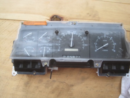 1993 Ford Bronco - Instrument cluster from a Ford truck, a speedometer, tachometer, and gear indicator. The text 'SUPERMOTORS' is visible at the bottom.