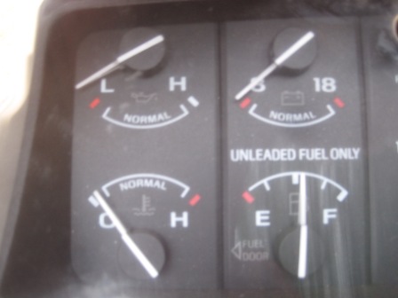 1993 Ford Bronco - Dashboard gauges display oil, battery, fuel, and temperature readings. 'UNLEADED FUEL ONLY' is printed.