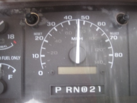 1993 Ford Bronco - Close-up of a vehicle's dashboard gauges, including the speedometer, fuel gauge, and gear selector.