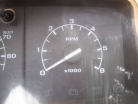 1993 Ford Bronco - Close-up of a vehicle's dashboard gauges, showing RPM and speed readings.
