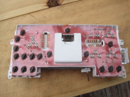 1993 Ford Bronco - Dashboard instrument cluster circuit board with red traces and black connectors, viewed from the back.