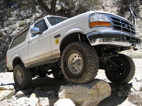 1996 Ford Bronco - This lifted Ford Bronco navigates a rocky terrain, its off-road capabilities.