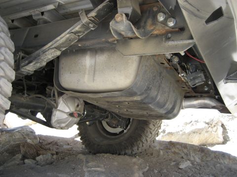 1996 Ford Bronco - This image shows the undercarriage of a vehicle, focusing on the rear axle, fuel tank, and suspension components.