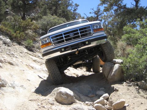 1996 Ford Bronco - Ford Bronco navigating a challenging rocky trail during an off-road excursion.