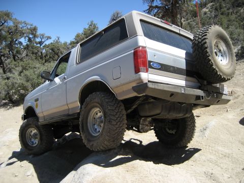 1996 Ford Bronco - This Ford Bronco is navigating rough terrain on a sunny day.