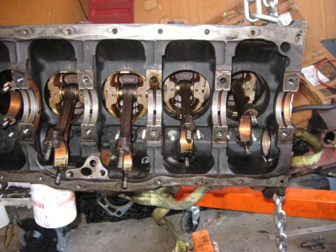 1981 Ford Bronco - Engine block assembly showing pistons and connecting rods during a rebuild process.