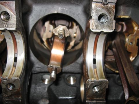 1981 Ford Bronco - Close-up view of engine crankshaft bearings and connecting rods, indicating internal engine components.