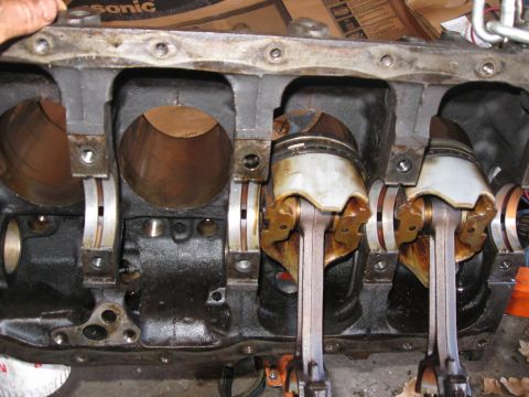 1981 Ford Bronco - The long and tedious task of removing the pistons. I thought they'd pull right out the bottom, but they don't. I had to pull them down into…