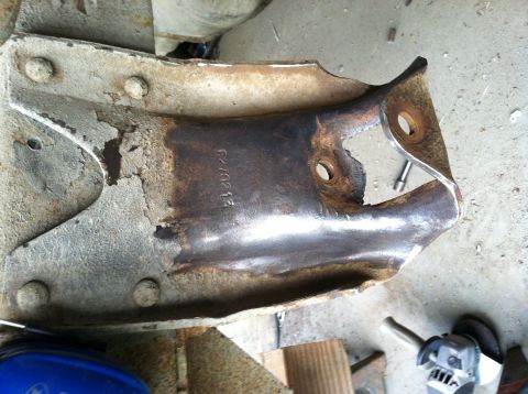 1983 Chevrolet C/K Pickup - A close-up view of a heavily rusted metal bracket with the stamped identification number G70215.