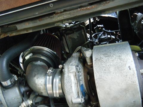 1988 Ford E350 - Close-up view of engine components, including a turbocharger and air intake system.