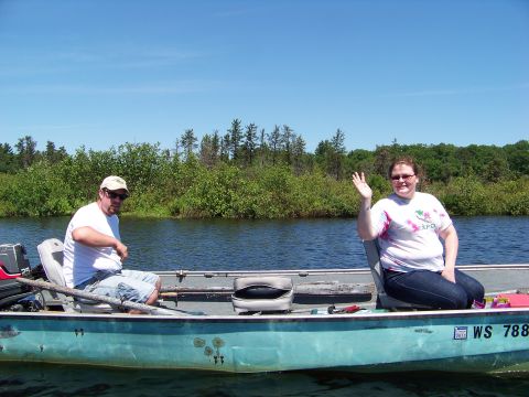 1996 Ford F-150 - A man and woman enjoy a sunny day fishing on the water.