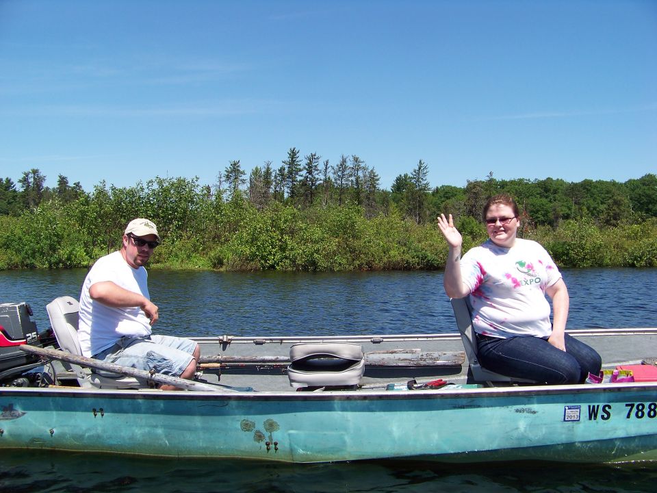 Two people in a fishing boat on a lake