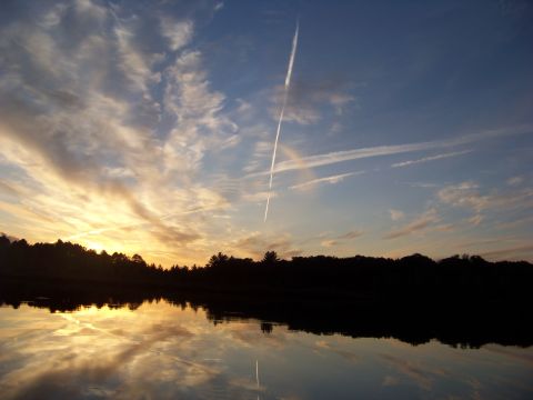 1996 Ford F-150 - A picturesque sunset reflects on the water, with a plane's contrail streaking across the sky.
