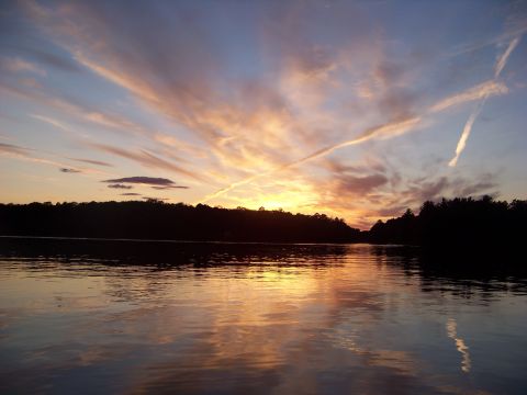 1996 Ford F-150 - A lake scene at sunset, with vibrant clouds painting the sky and reflecting on the water's surface.