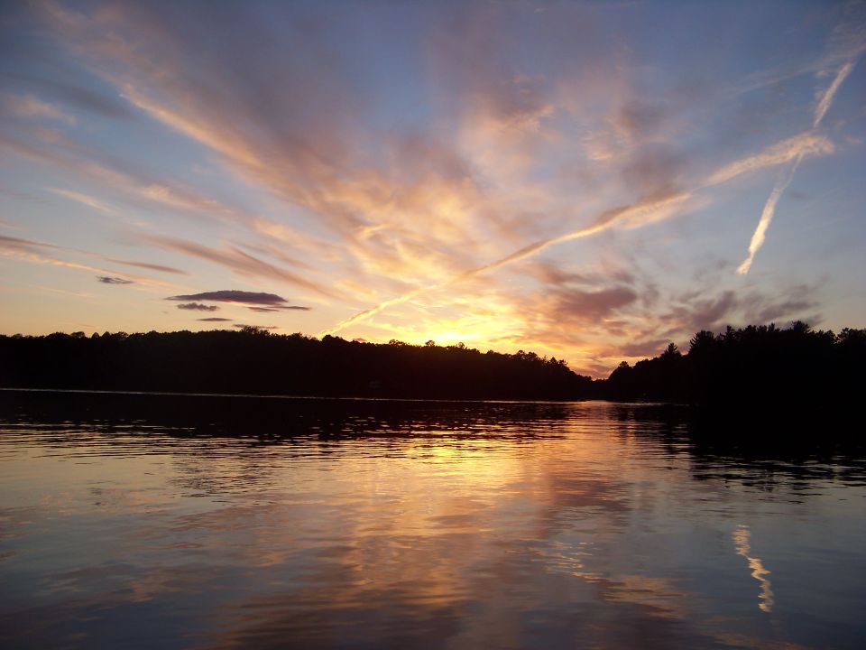 Lake at sunset with colorful clouds and reflections