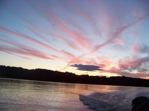 1996 Ford F-150 - Sunset over a lake with a boat wake visible, during a fishing trip.