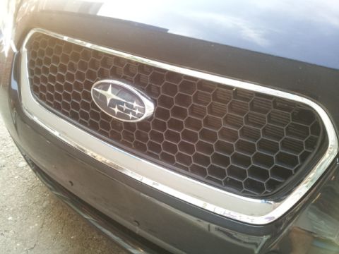 2008 Subaru Legacy - Close-up of a Subaru grille a honeycomb pattern and chrome accents. The Subaru logo is centered.