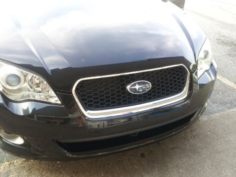 2008 Subaru Legacy - Front view of a black 2008 Subaru Legacy, highlighting its distinctive grille with chrome accents and the Subaru emblem.