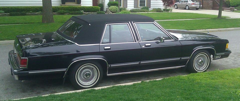 black 1991 Mercury Grand Marquis sedan parked on street, side view