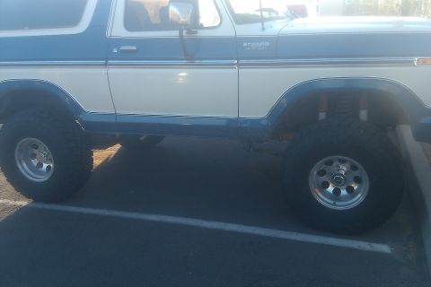 1979 Ford Bronco - This two-tone blue and white 1979 Ford Bronco features a lifted suspension and off-road tires.