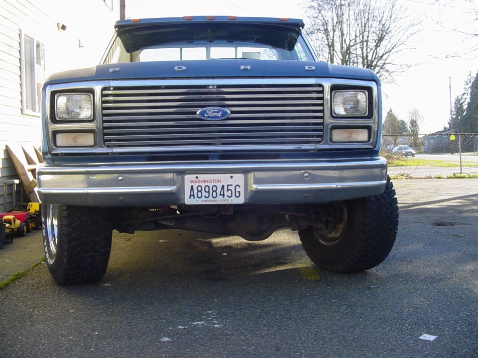 Front view of a blue 1980s Ford 4x4 with chrome grille and Washington plate