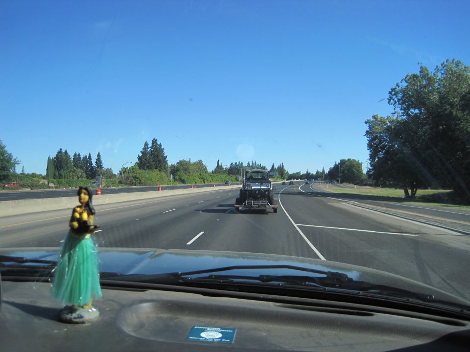 Truck being towed on a highway, viewed from inside a vehicle