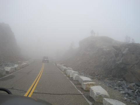 1989 Ford Bronco - Driving through heavy fog on a mountain pass, visibility is extremely limited.