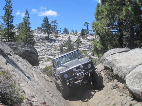 1989 Ford Bronco - This 1989 Ford Bronco is tackling a challenging off-road course in a mountainous, rocky landscape.