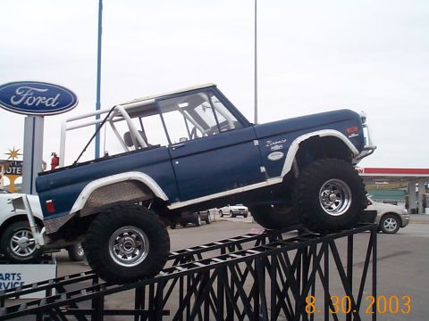1977 Ford Bronco - This 1977 Ford Bronco is positioned on a ramp, with a Ford dealership sign visible.