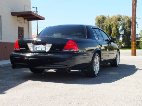 2003 Ford Crown Victoria - Rear-right view of a black sedan; P71 badge, EVIL VIC plate and dual exhaust tip.
