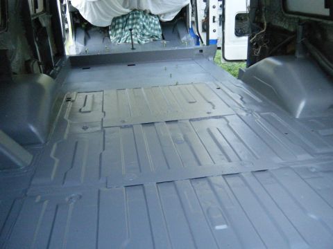 1988 Ford E350 - The cargo area of a 1988 Ford E350 van has been prepped and painted gray.