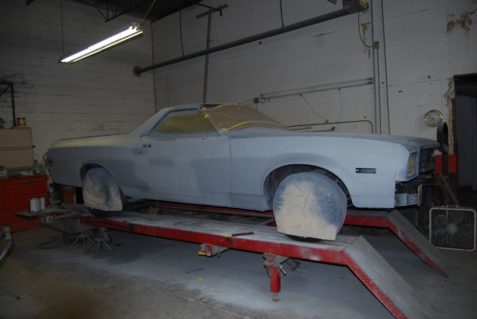 1975 Ford Ranchero side view on lift, primed body