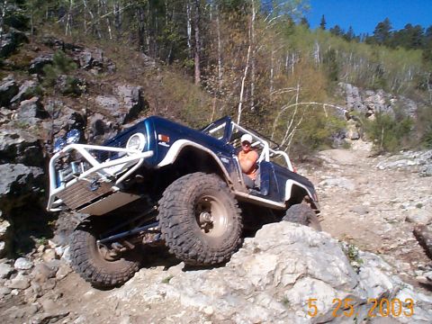 1977 Ford Bronco - This modified 1977 Ford Bronco navigates a challenging rocky trail, its off-road capabilities.
