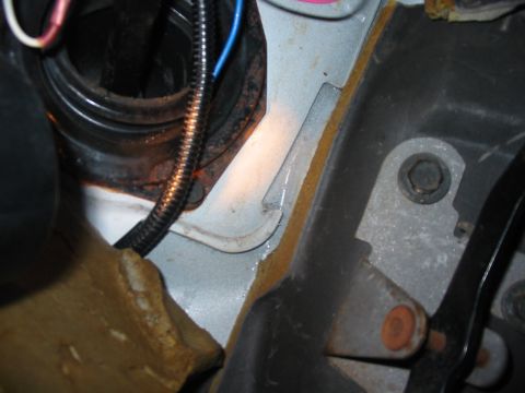 1992 Ford Bronco - This image shows a section of a vehicle's engine bay, focusing on wiring and the firewall, with signs of rust and potential water ingress.