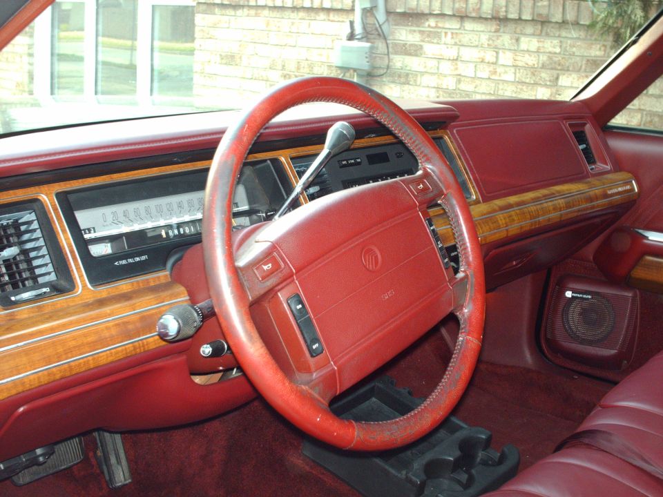1991 Mercury Grand Marquis interior with red seats, wood trim, and steering wheel