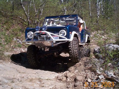 1977 Ford Bronco - Off-roading in a modified 1977 Ford Bronco on a challenging rocky path.