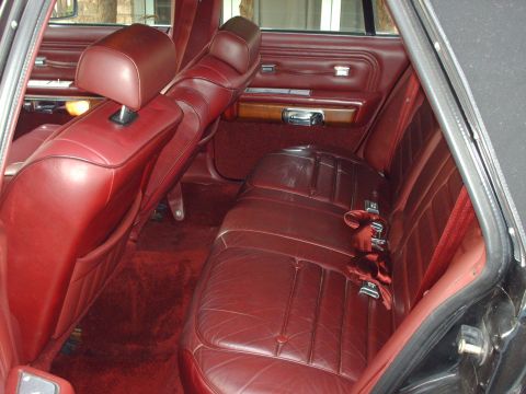 1991 Mercury Grand Marquis - The interior of a 1991 Mercury Grand Marquis features red leather seats and plush carpeting.