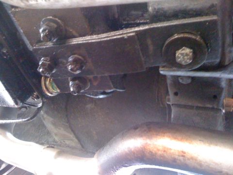 1964 Ford Ranchero - Underside view of a vehicle's suspension components, including a leaf spring and U-bolt assembly.